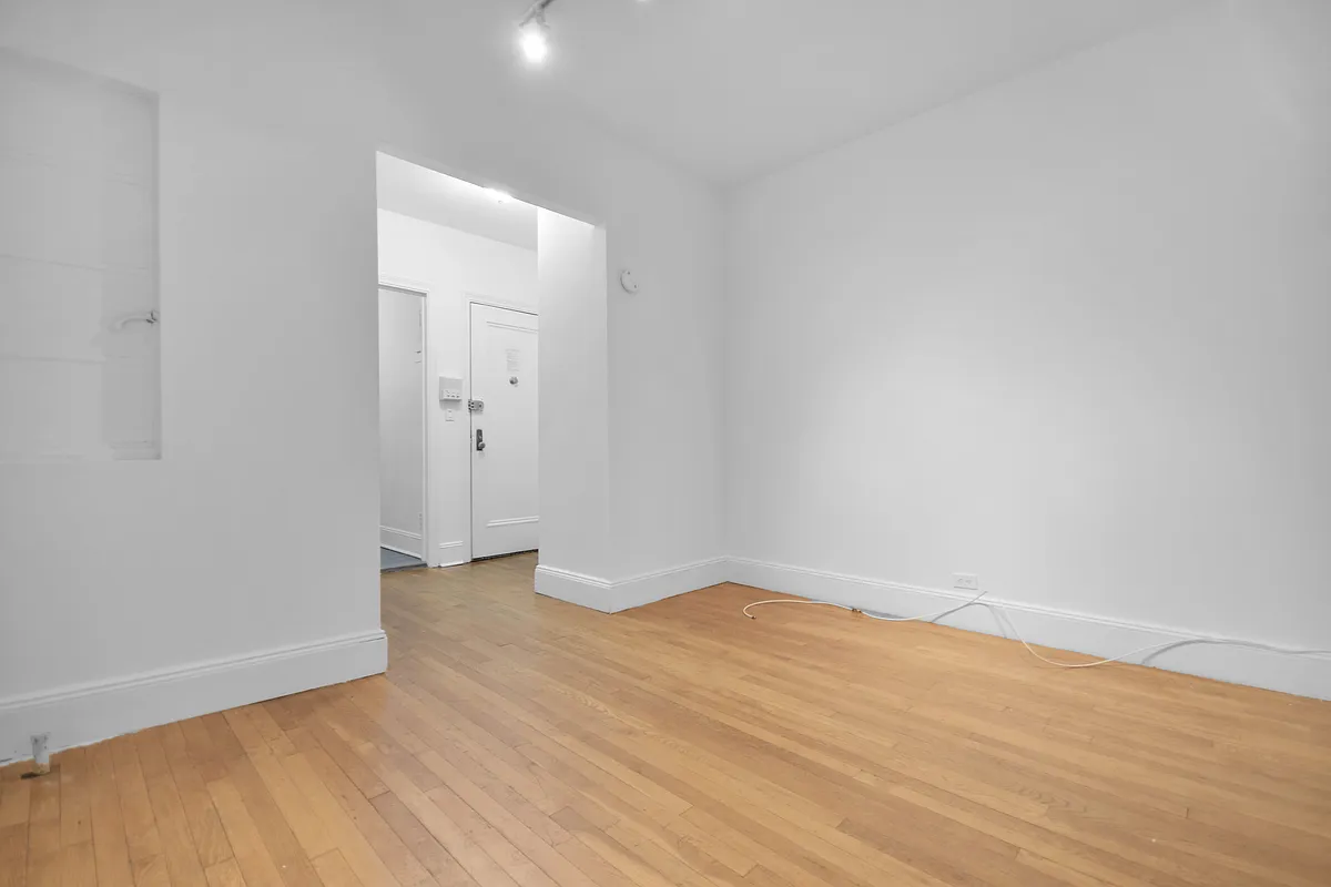 209 East 88th Street, Unit 4B Manhattan, NY 10128 - Photo 3 of 5 a view of an empty room with wooden floor