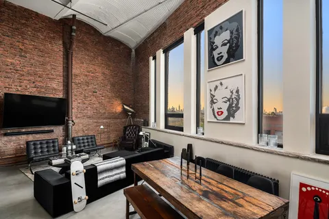 a bedroom with bed and a couch