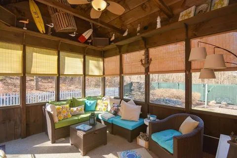 a living room with furniture and a floor to ceiling window
