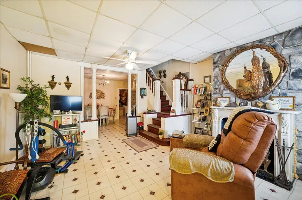 a living room with furniture a rug and white walls