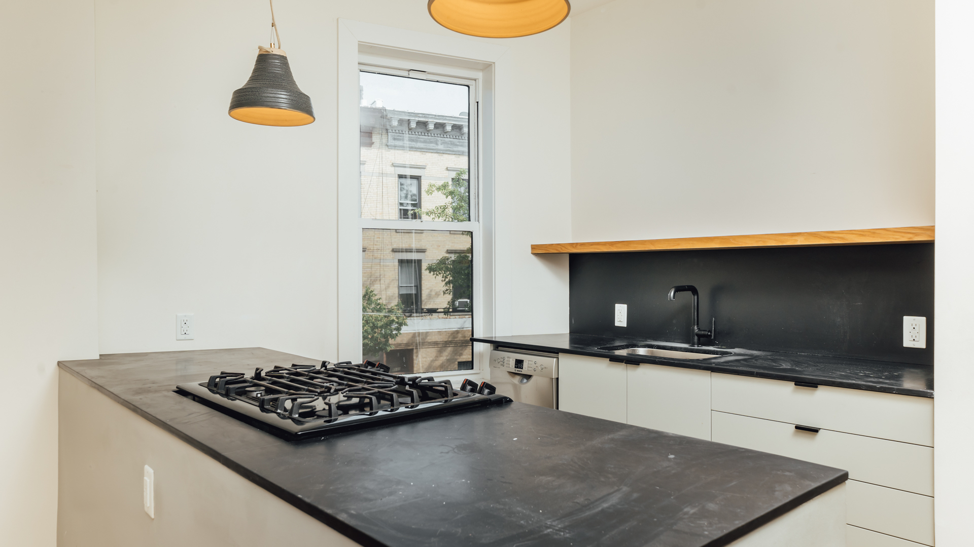 880 Woodward Avenue, Unit 2 Queens, NY 11385 - Photo 5 of 18 a kitchen with a stove and a microwave