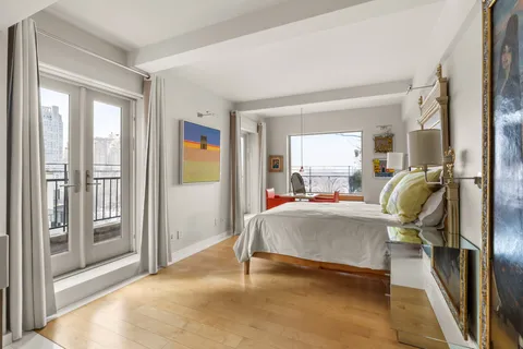 a bed room with a bed and a chair