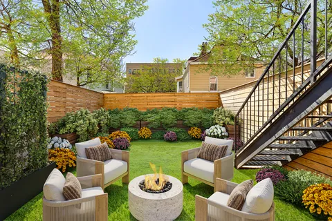 a view of a patio with couches table and chairs and potted plants