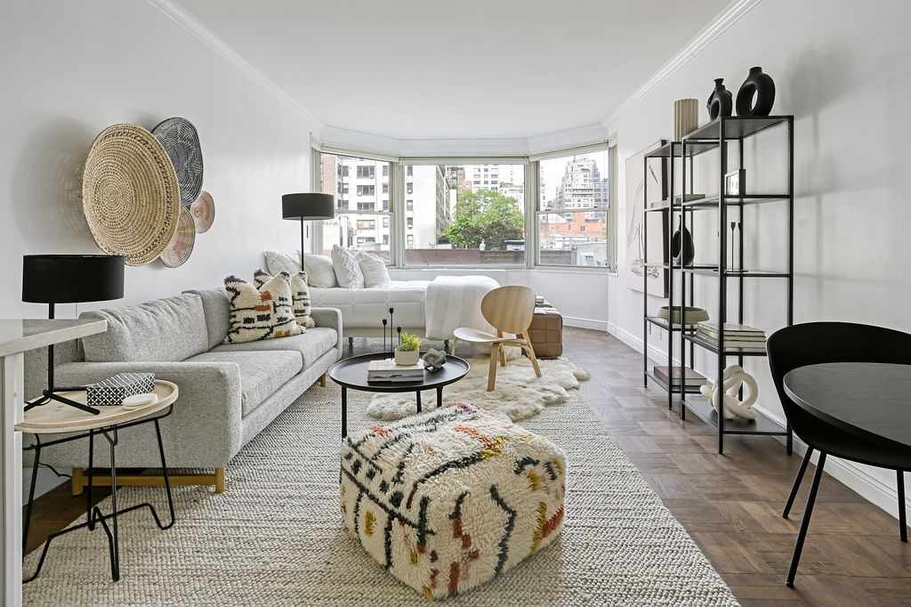 a living room with furniture fireplace and a large window