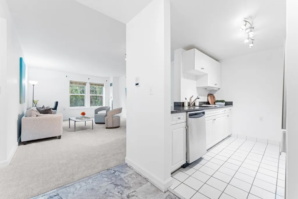 a kitchen with white cabinets and white appliances