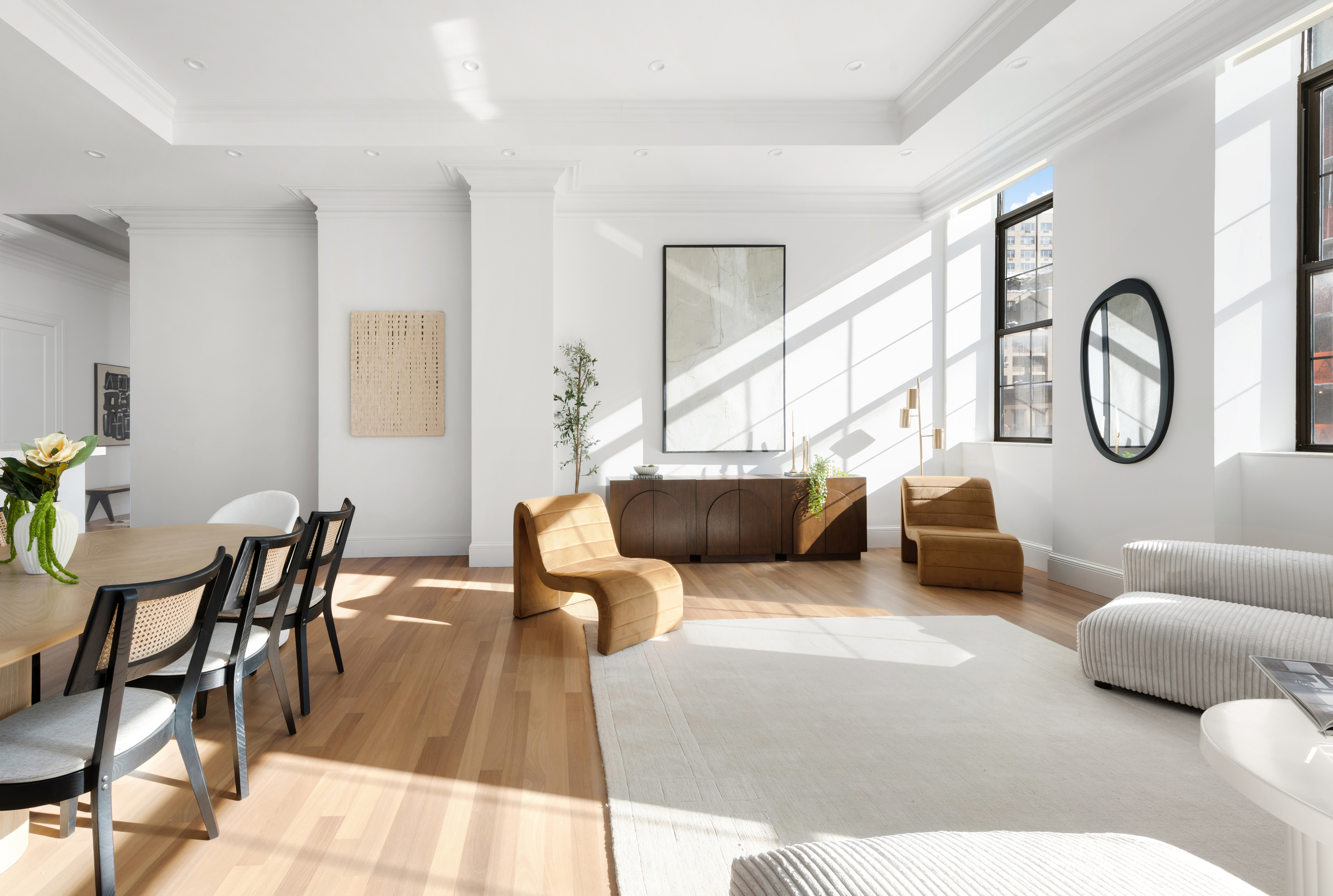 351 East 51st Street, Unit L5C Manhattan, NY 10022 - Photo 2 of 18 a living room with furniture and a large window