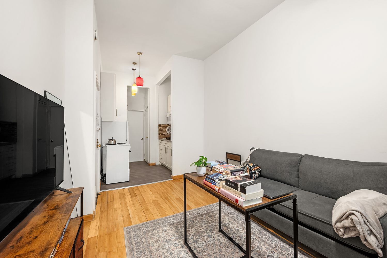 430 East 85th Street, Unit 1B Manhattan, NY 10028 - Photo 3 of 8 a living room with furniture and a flat screen tv