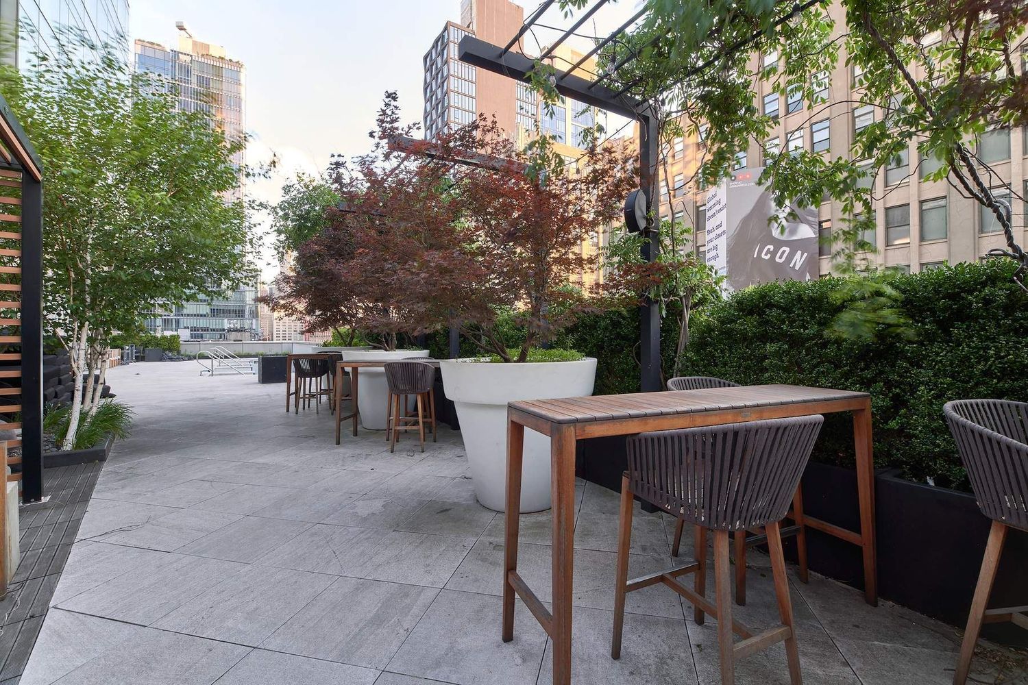 246 Spring Street, Unit 4111 Manhattan, NY 10013 - Photo 17 of 19 a view of backyard with seating and trees