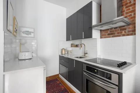 a kitchen with stainless steel appliances a sink a stove and a refrigerator