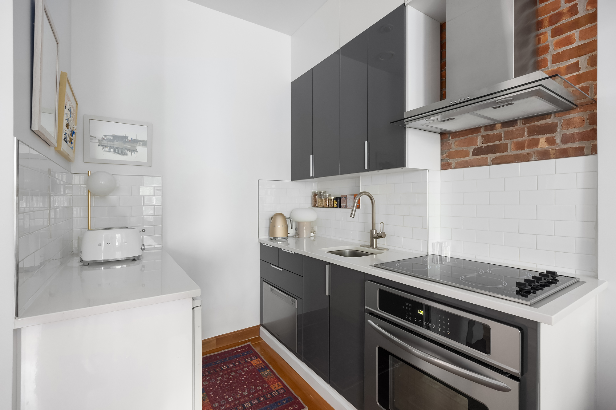 27 West 82nd Street, Unit 2B Manhattan, NY 10024 - Photo 4 of 11 a kitchen with stainless steel appliances a sink a stove and a refrigerator