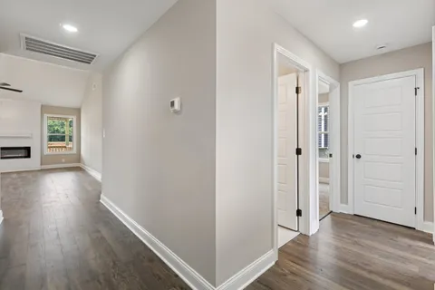 a view of hallway with wooden floor