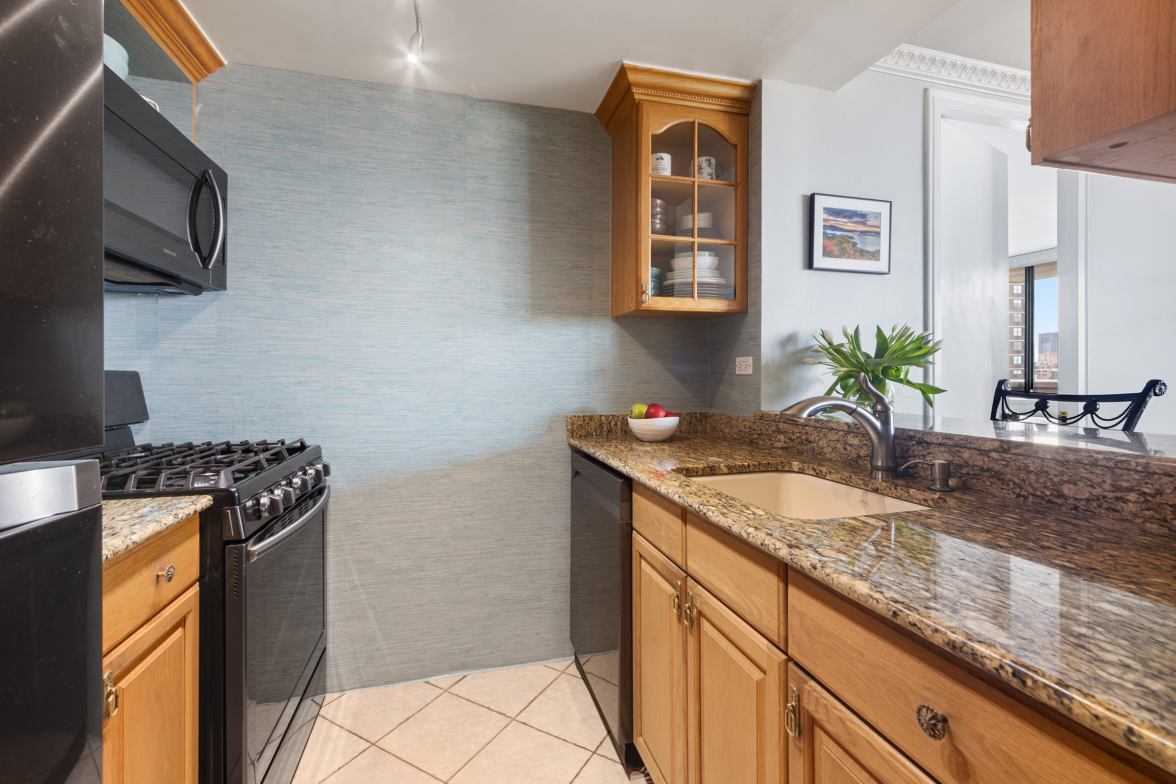 233 East 86th Street, Unit PHB Manhattan, NY 10028 - Photo 5 of 12 a kitchen with stainless steel appliances granite countertop a sink stove and refrigerator