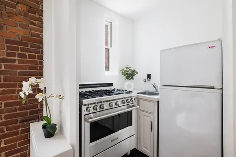a kitchen with a stove and a refrigerator