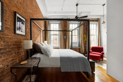 a bedroom with a bed window and walk in closet