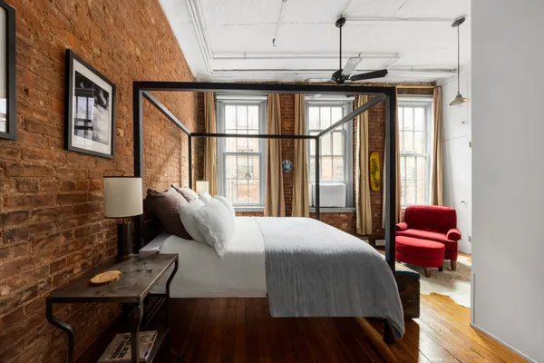 a bedroom with a bed window and walk in closet
