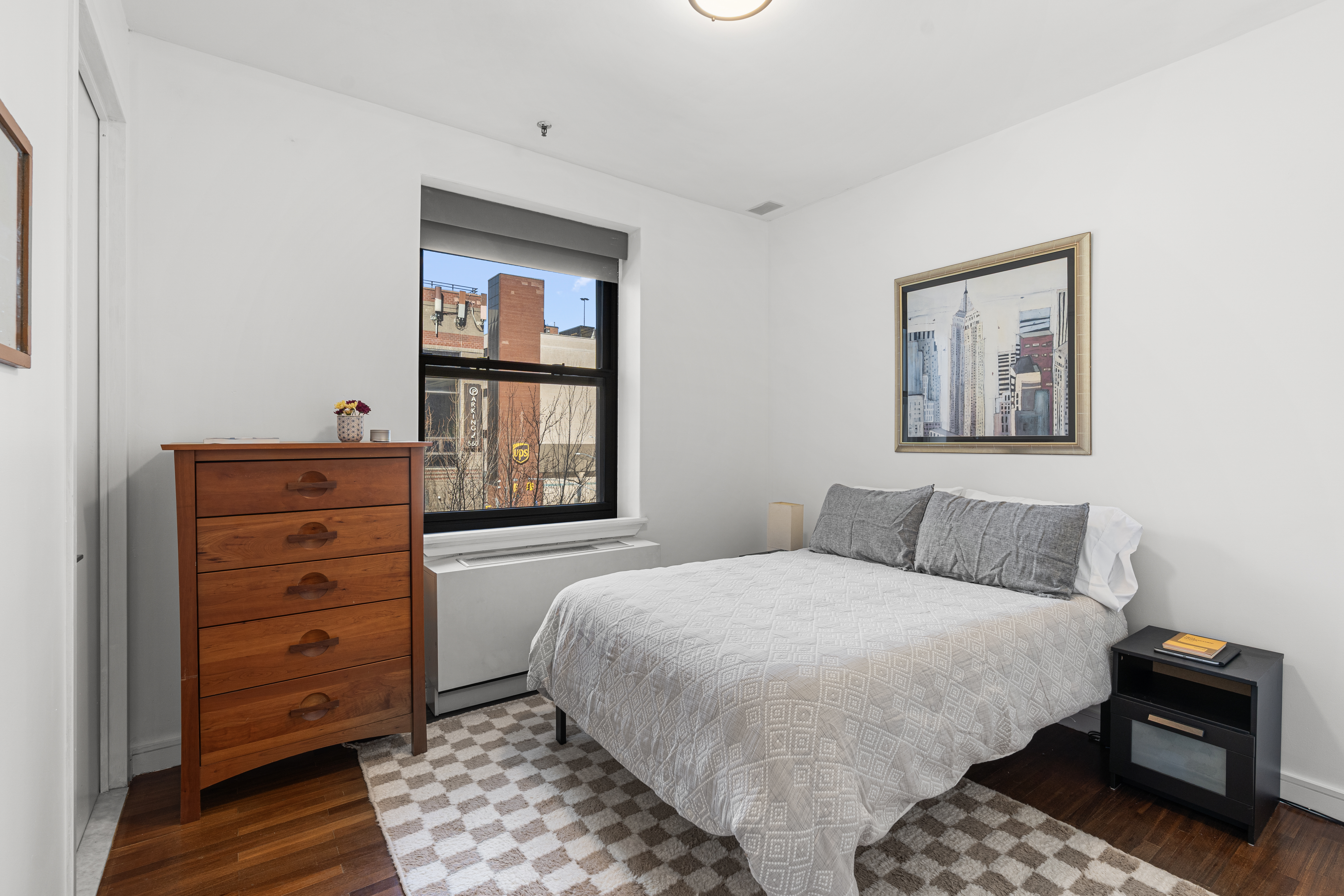 552 West 43rd Street, Unit 3A Manhattan, NY 10036 - Photo 5 of 11 a bedroom with a bed and a dresser