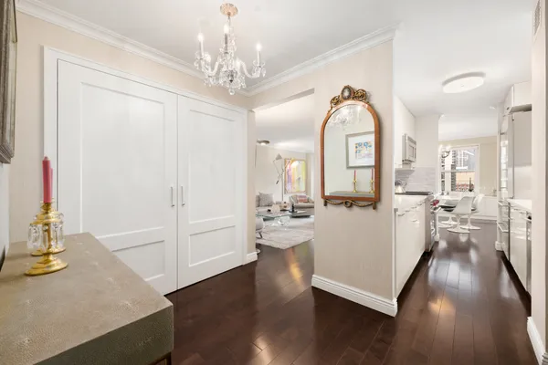 a view of a living room and chandelier with wooden floor