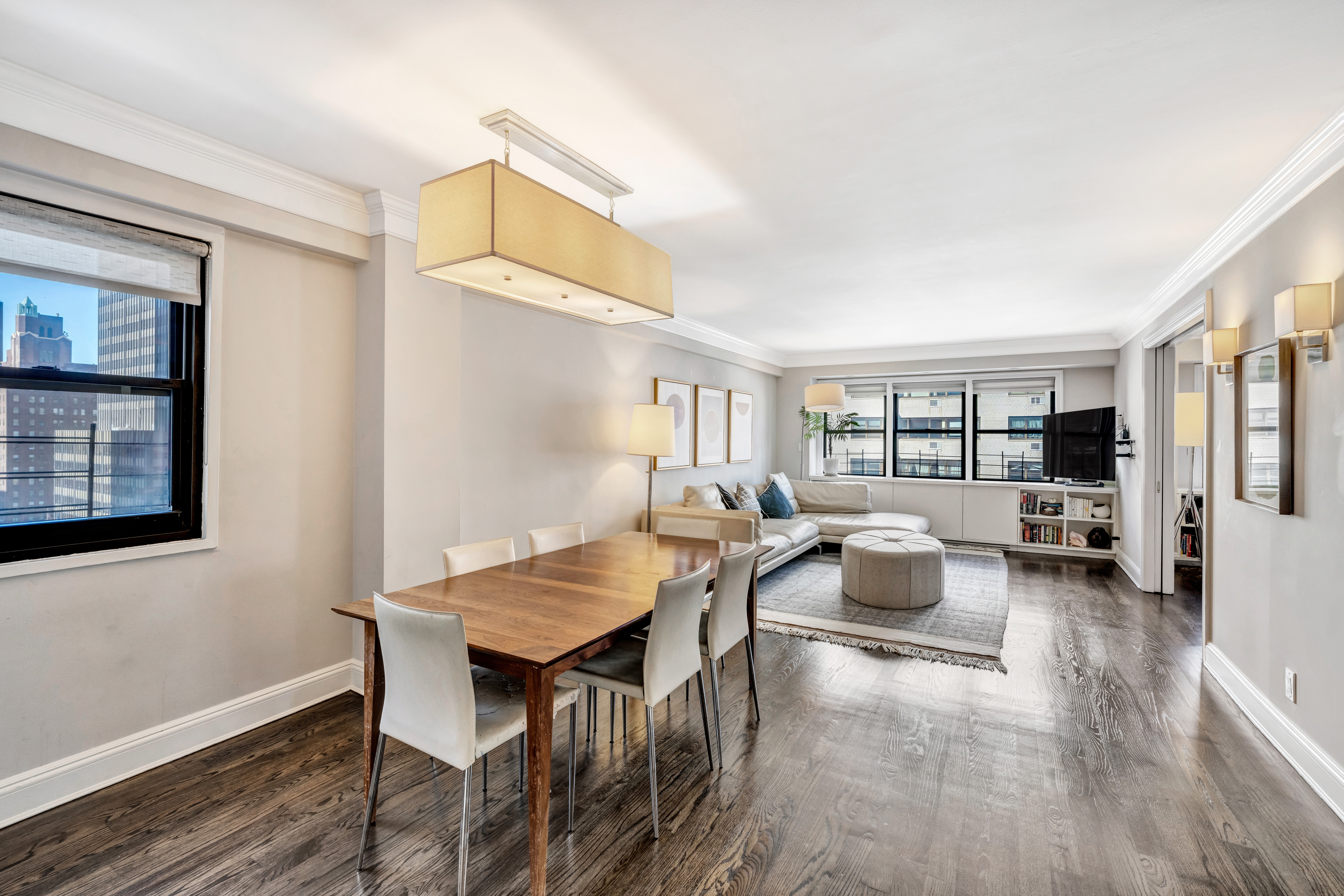 411 East 57th Street, Unit 11AB Manhattan, NY 10022 - Photo 3 of 17 a living room with furniture and a window