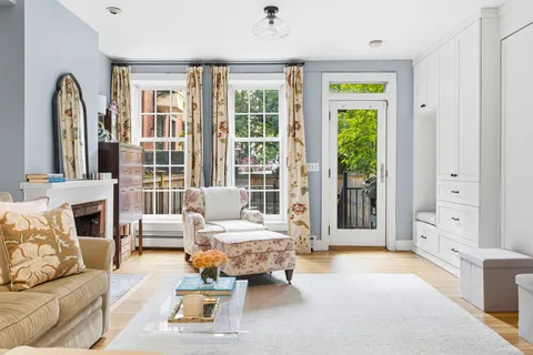 a living room with furniture and large windows