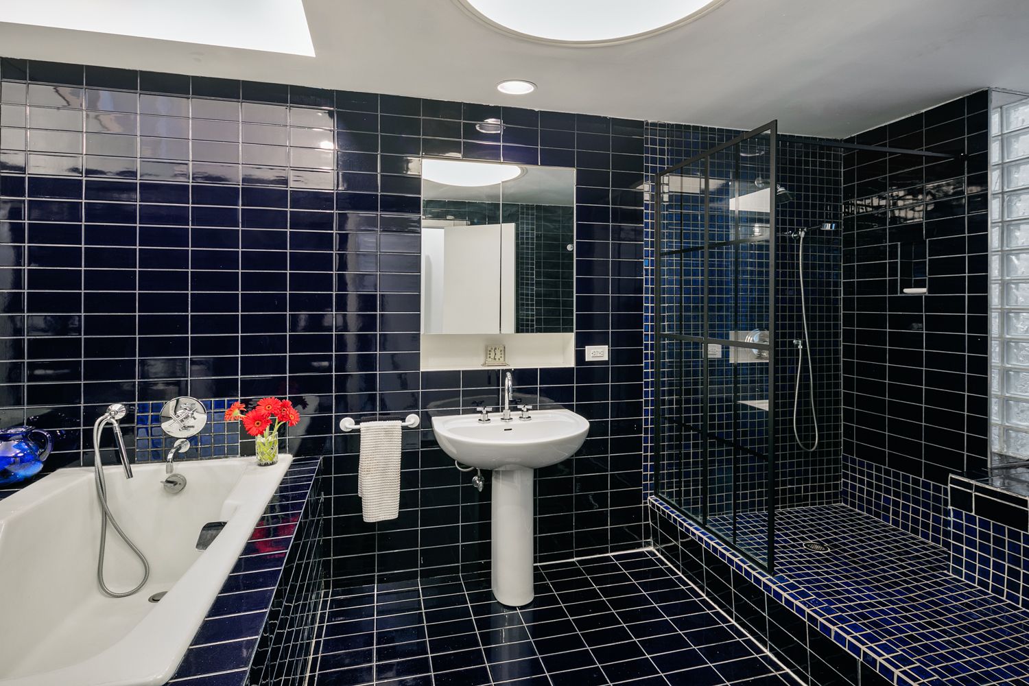 366 Broadway, Unit 3C Manhattan, NY 10013 - Photo 8 of 10 a bathroom with a sink toilet shower and a mirror