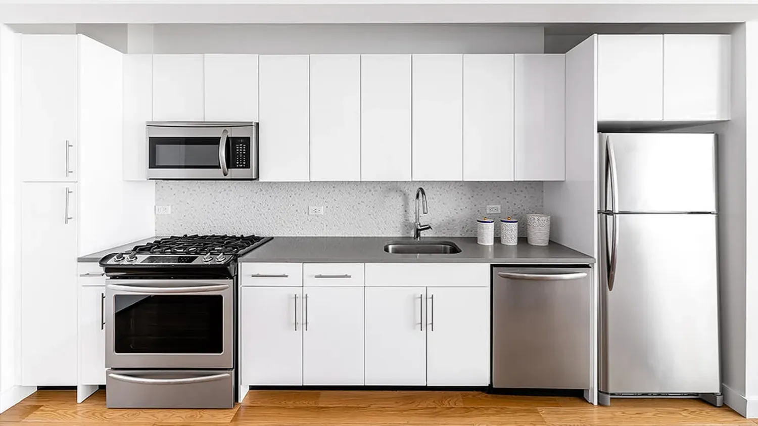 a kitchen with stainless steel appliances granite countertop a stove and a microwave