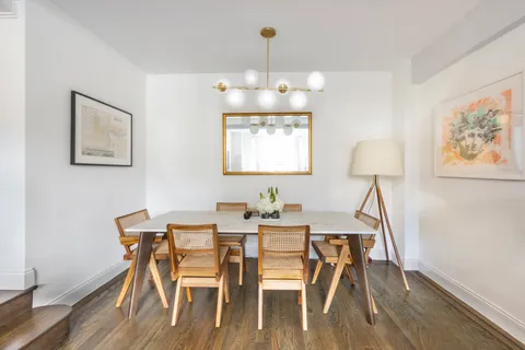a view of a dining room with furniture wooden floor and a chandelier