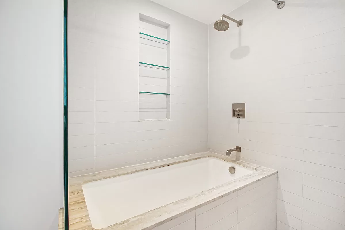 322 West 57th Street, Unit 38Q Manhattan, NY 10019 - Photo 8 of 16 a bathroom with a tub and a sink