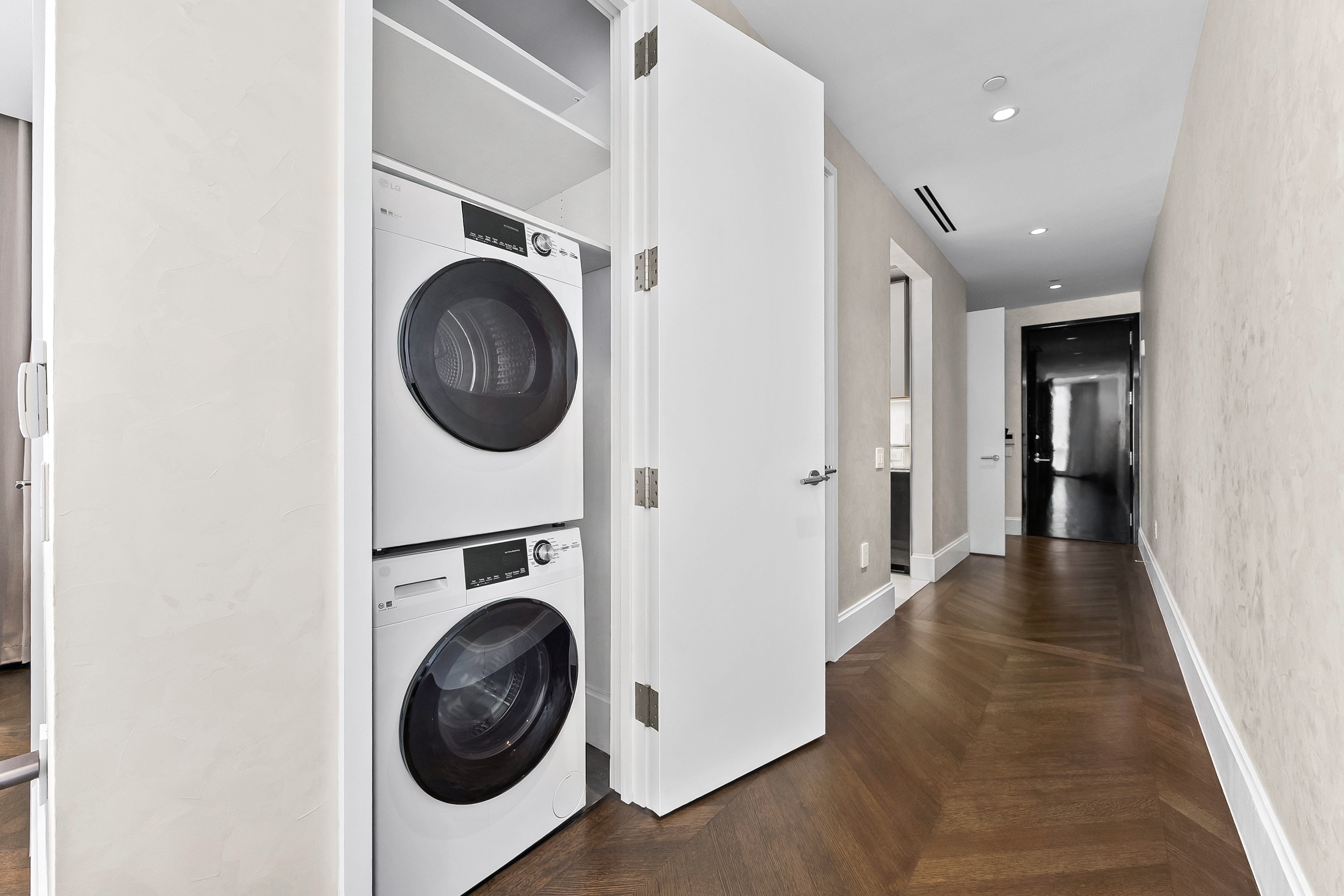 217 West 57th Street, Unit 36D Manhattan, NY 10019 - Photo 18 of 26 a view of a hallway with washer and dryer
