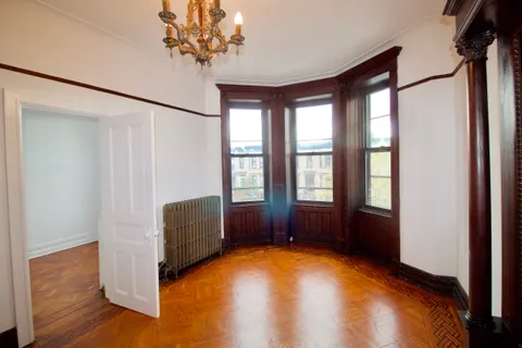 a view of room with window and hardwood floor