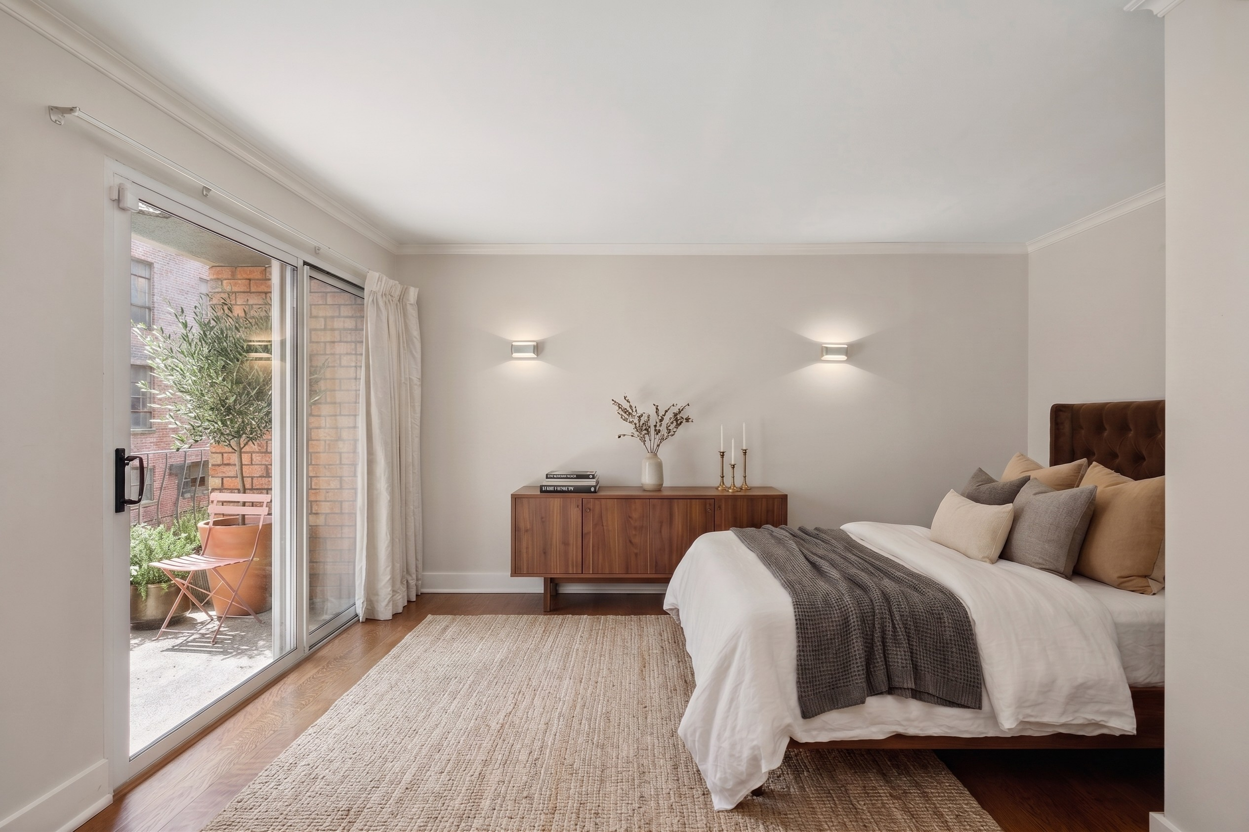 170 East 88th Street, Unit 1C Manhattan, NY 10128 - Photo 11 of 16 a bedroom with a bed and wooden floor