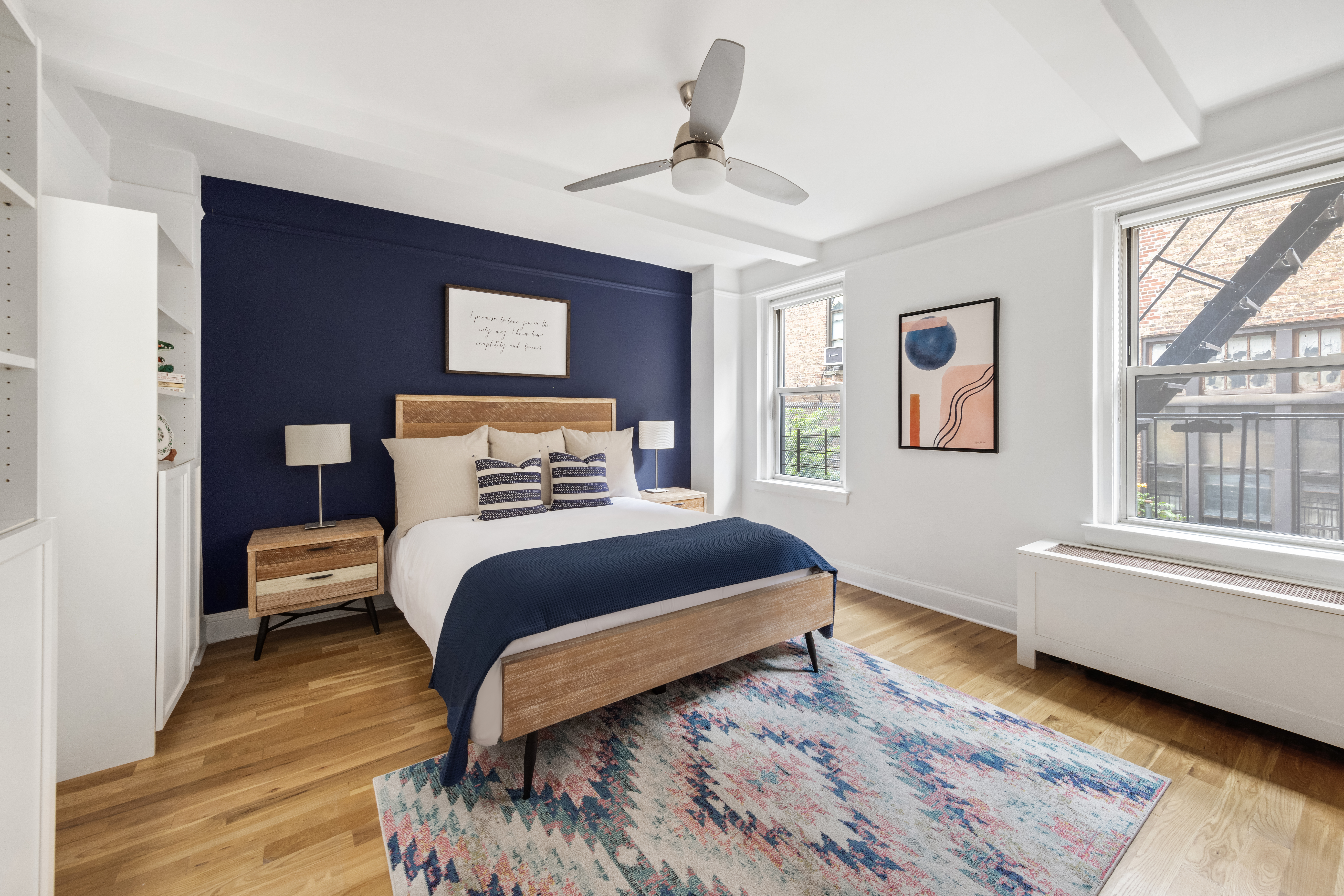 425 East 86th Street, Unit 2F Manhattan, NY 10028 - Photo 5 of 11 a bedroom with a bed and wooden floor
