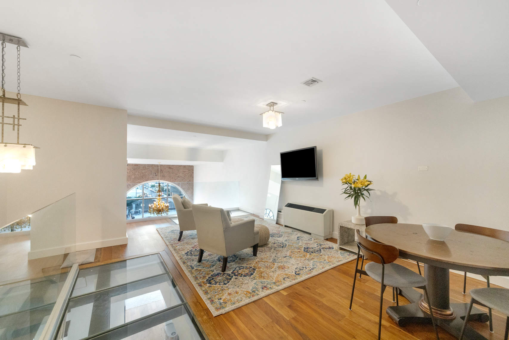 2-17 51st Avenue, Unit 606 Queens, NY 11101 - Photo 8 of 18 a living room with furniture and a table