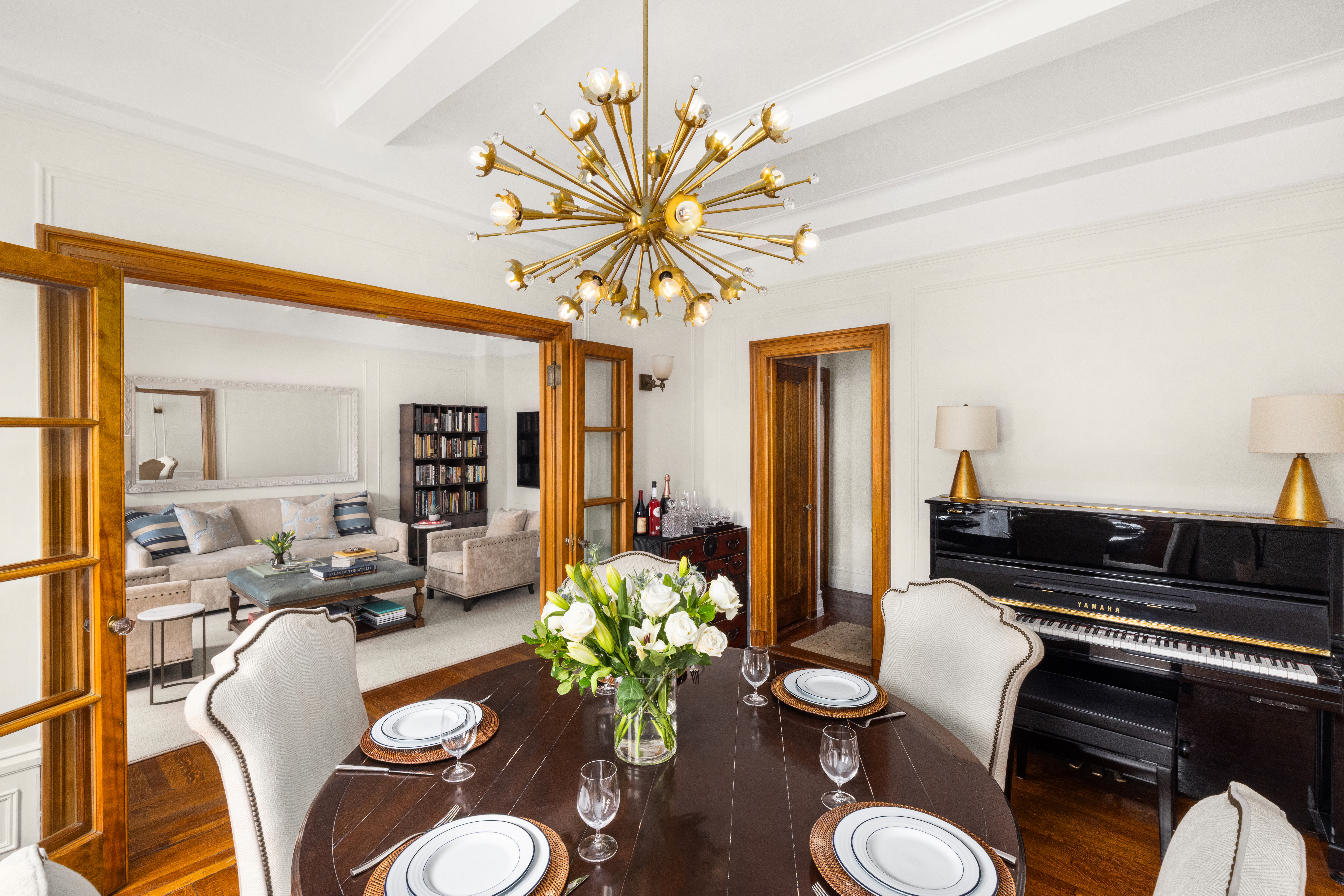 119 West 71st Street, Unit 9B Manhattan, NY 10023 - Photo 5 of 18 a living room with furniture flowers and a chandelier
