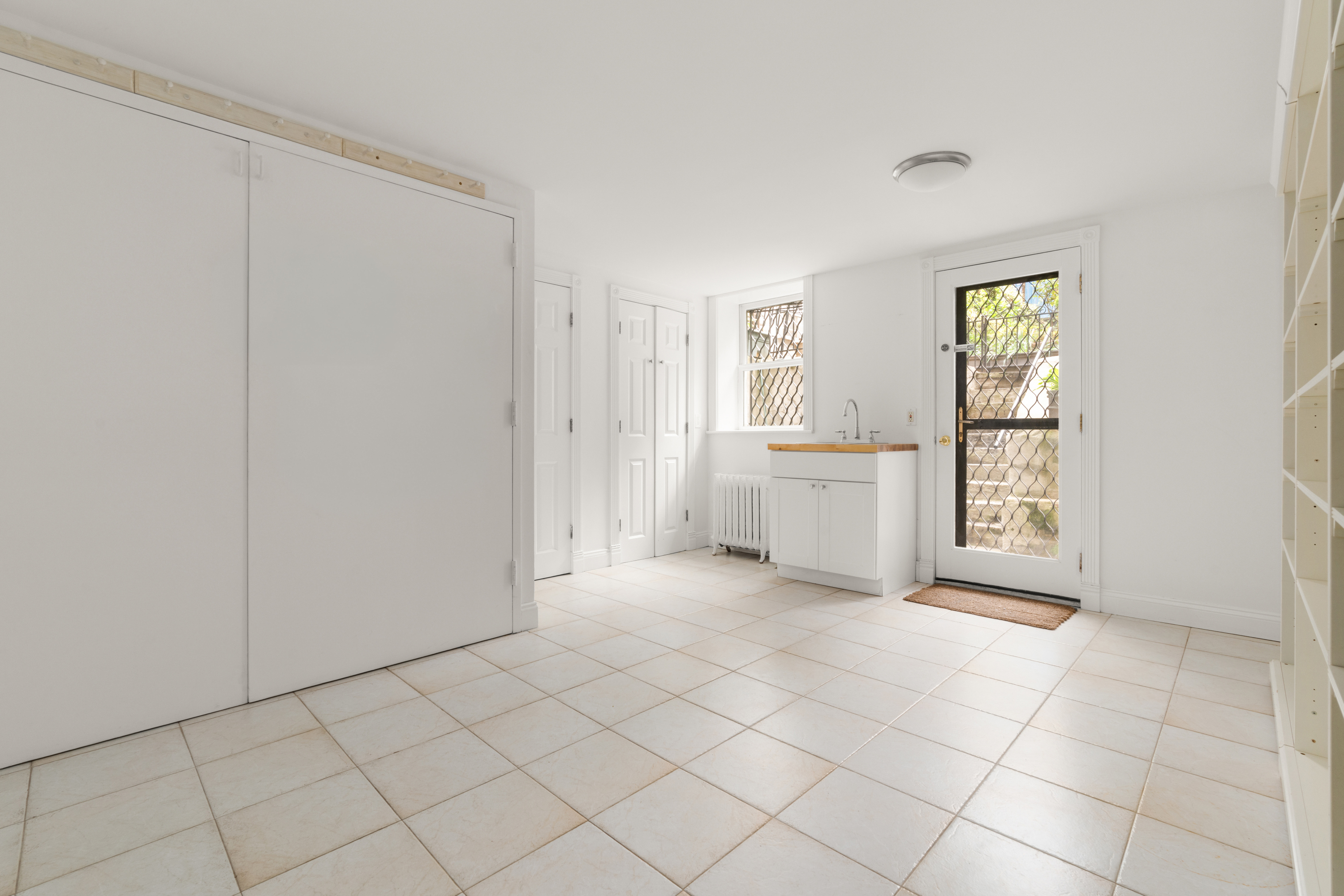 60 Hicks Street Brooklyn, NY 11201 - Photo 17 of 22 a view of an empty room with window and cabinet