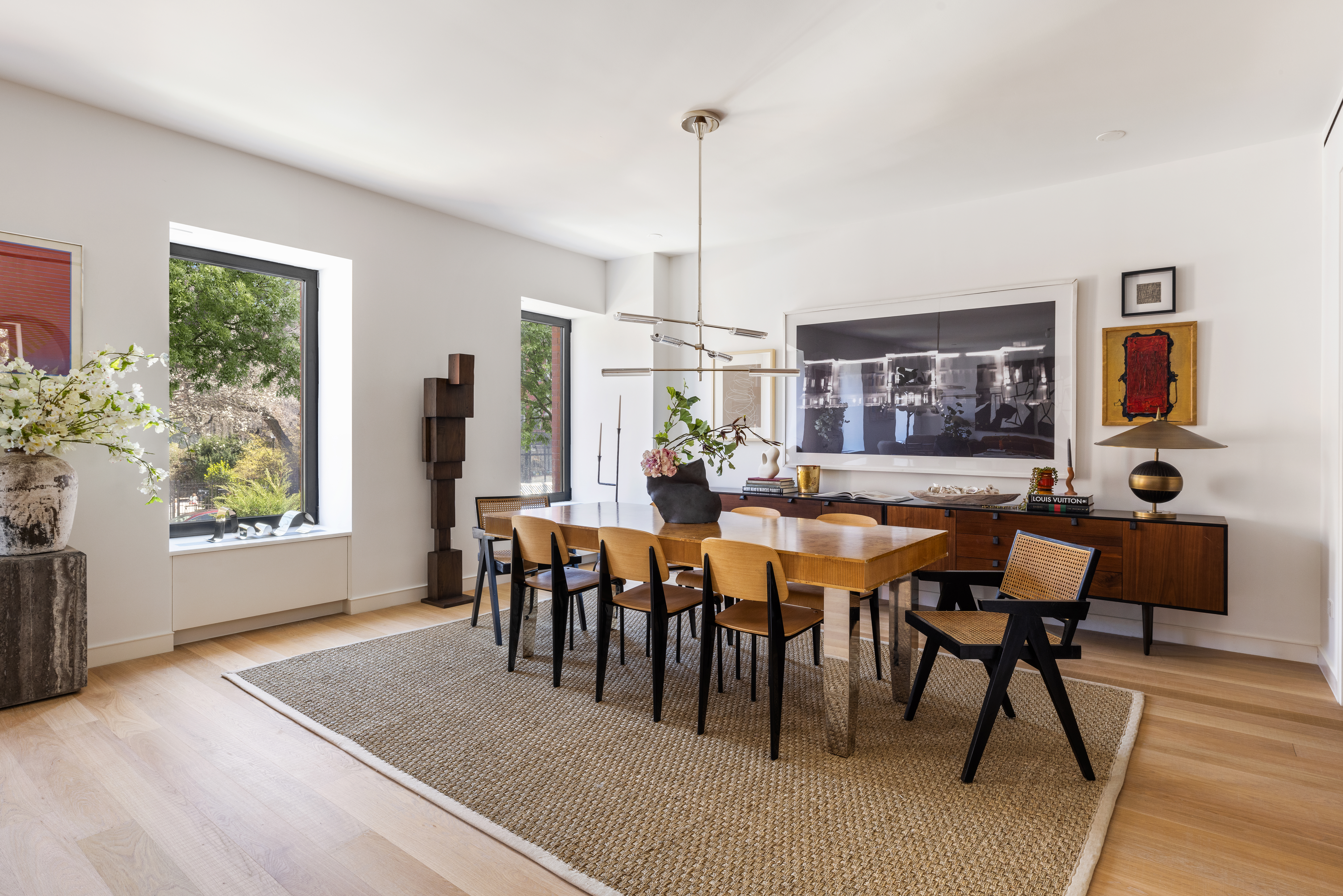 500 West 22nd Street, Unit 2A Manhattan, NY 10011 - Photo 2 of 19 a view of a dining room and livingroom with furniture wooden floor a rug a painting and a chandelier