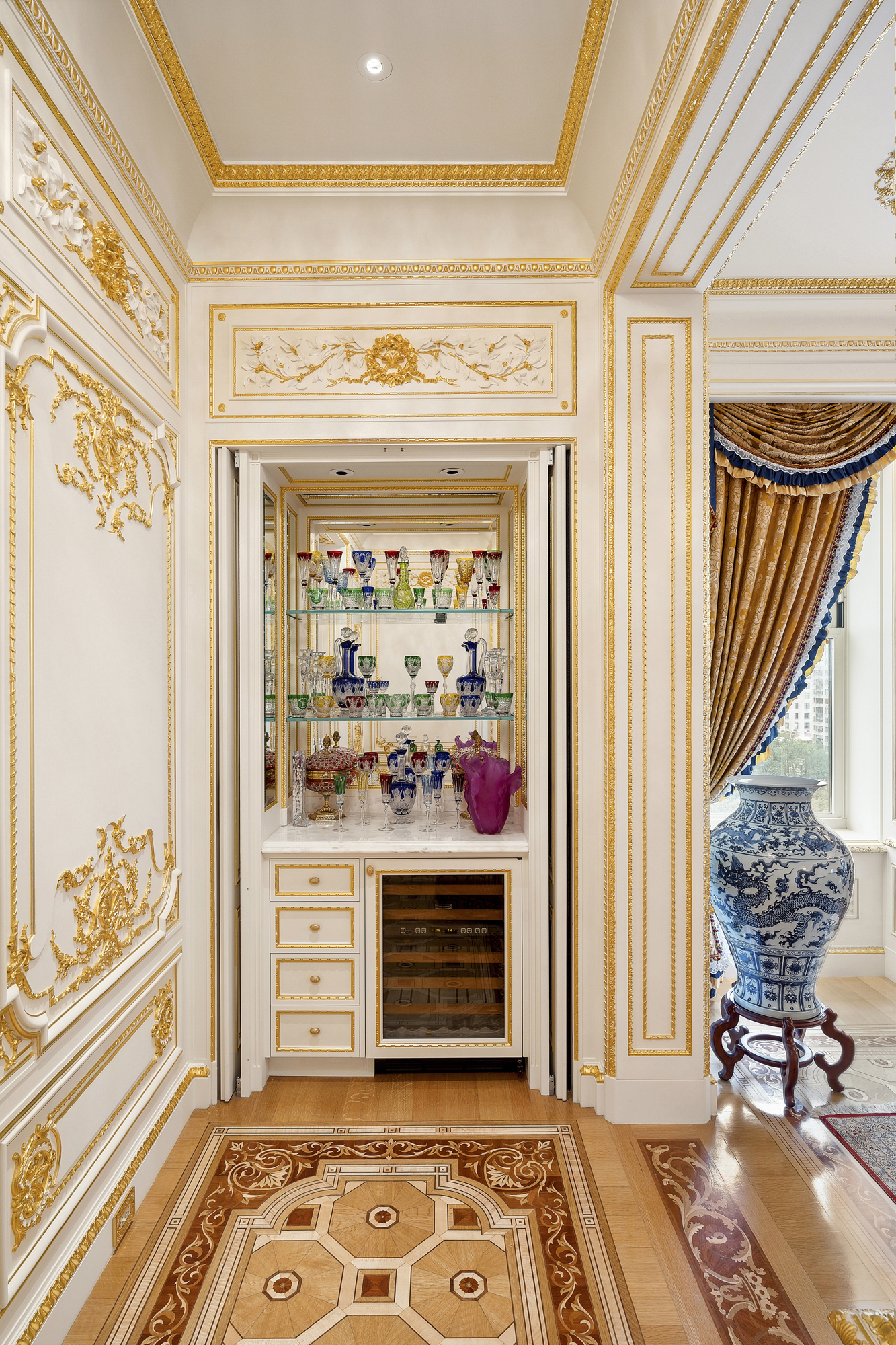 1 Central Park South, Unit 10071009 Manhattan, NY 10019 - Photo 18 of 28 a view of a hallway with wooden floor and a potted plant