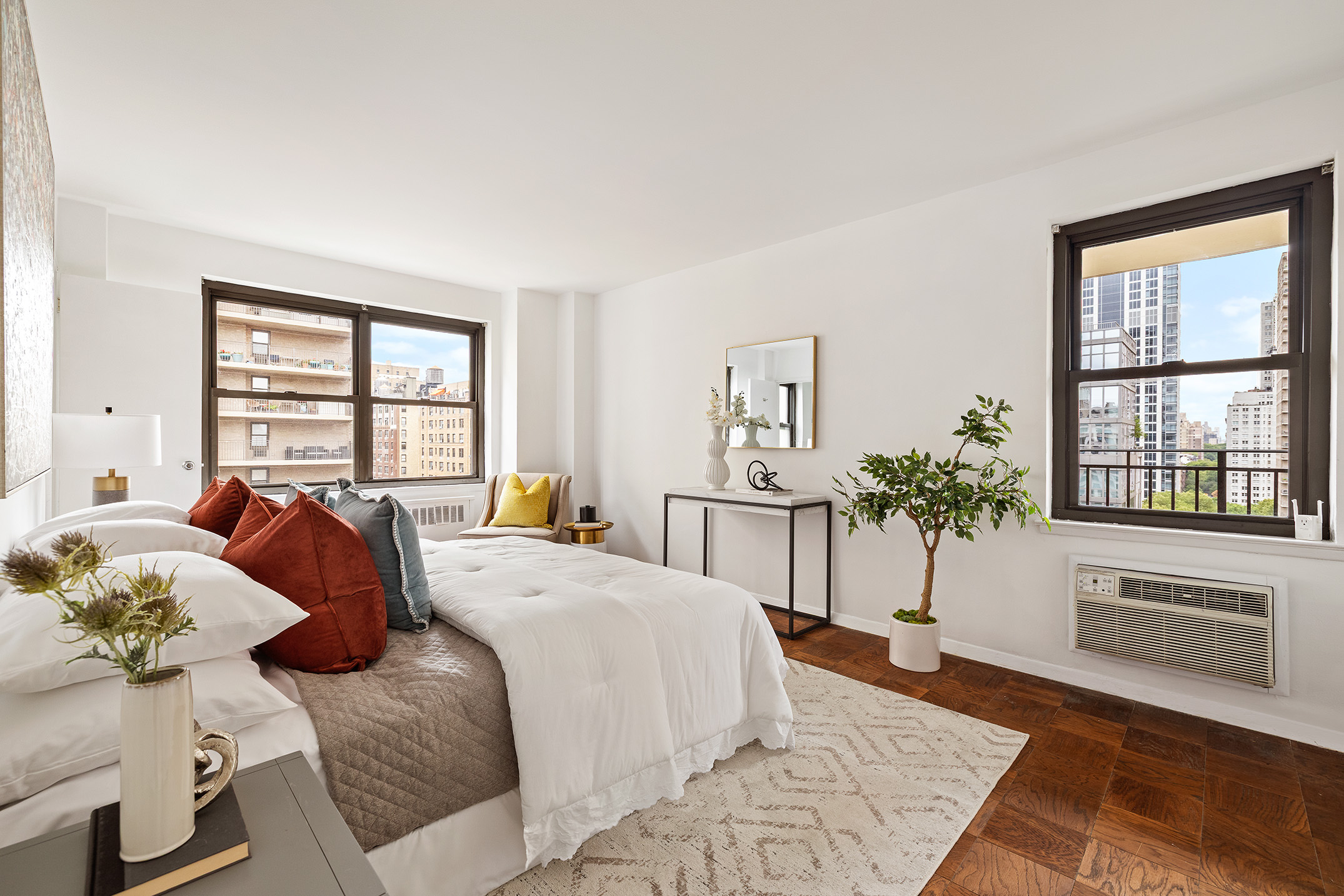 185 West End Avenue, Unit 16D Manhattan, NY 10023 - Photo 7 of 11 a bedroom with a bed and glass windows