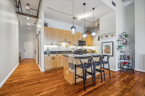a kitchen with refrigerator cabinets and wooden floor