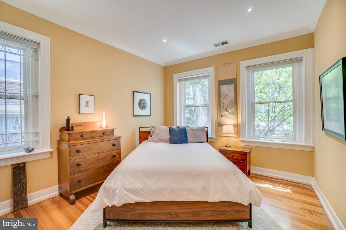 2415 20th Street Northwest, Unit 38 Washington, DC 20009 - Photo 16 of 30 a bedroom with a bed and wooden floor