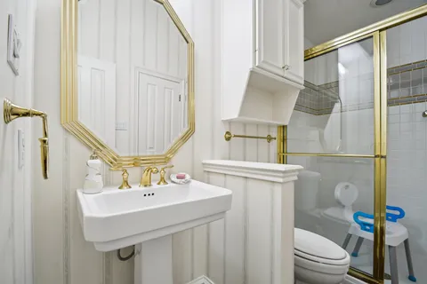 a bathroom with a sink a toilet and shower