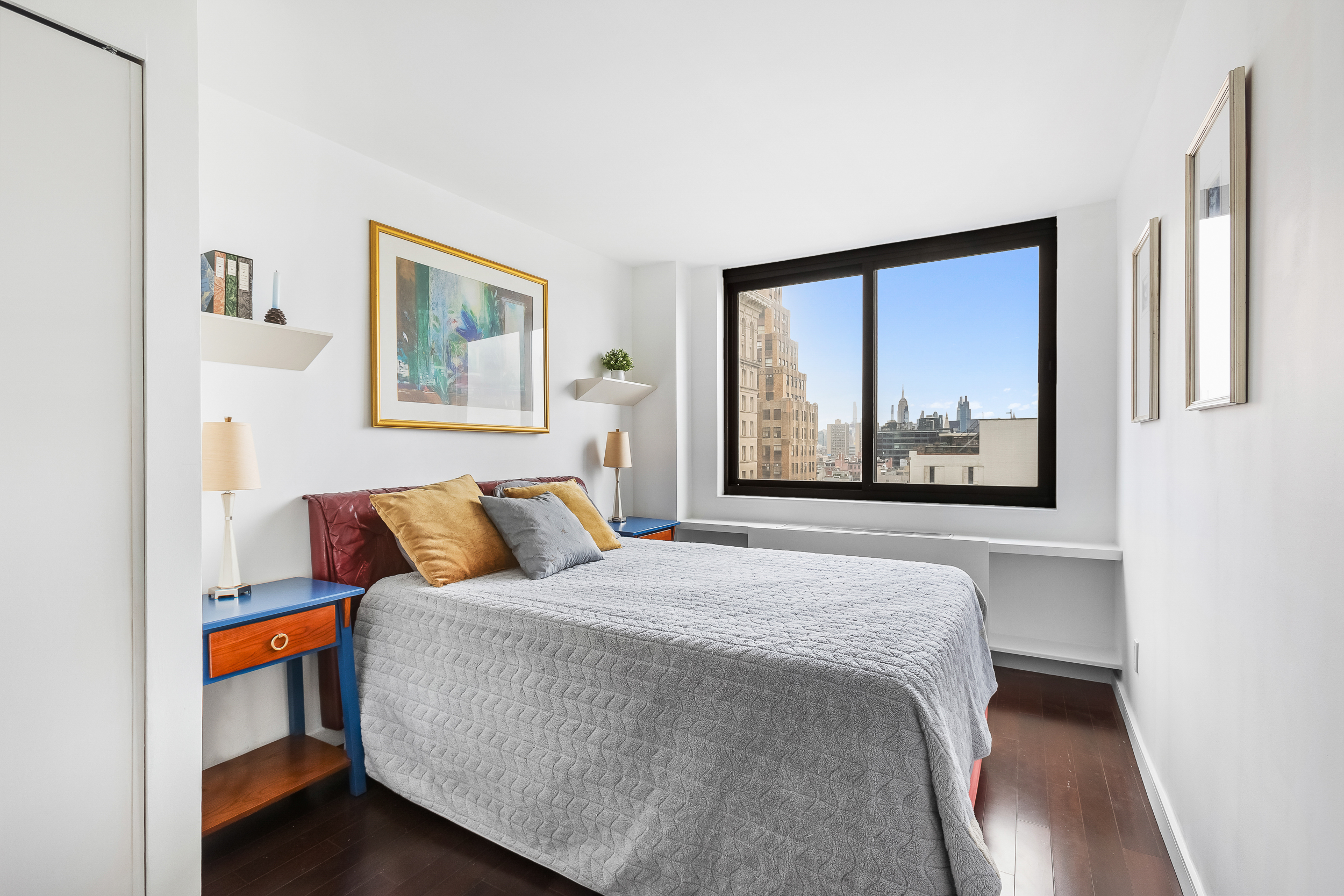 376 Broadway, Unit 14E Manhattan, NY 10013 - Photo 7 of 11 a bedroom with a bed and a painting on the wall