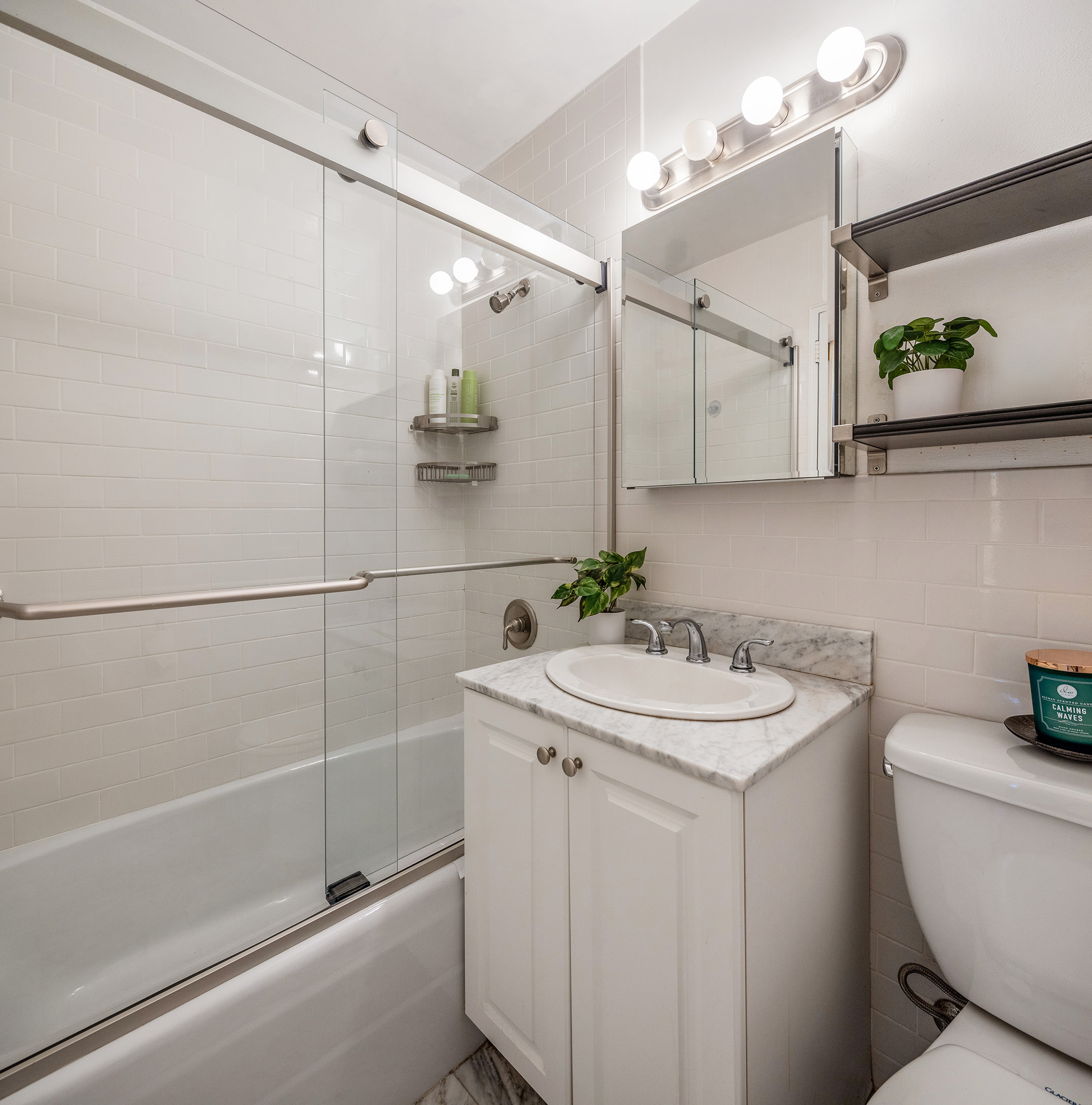 170 West End Avenue, Unit 12C Manhattan, NY 10023 - Photo 5 of 9 a bathroom with a sink a toilet and shower
