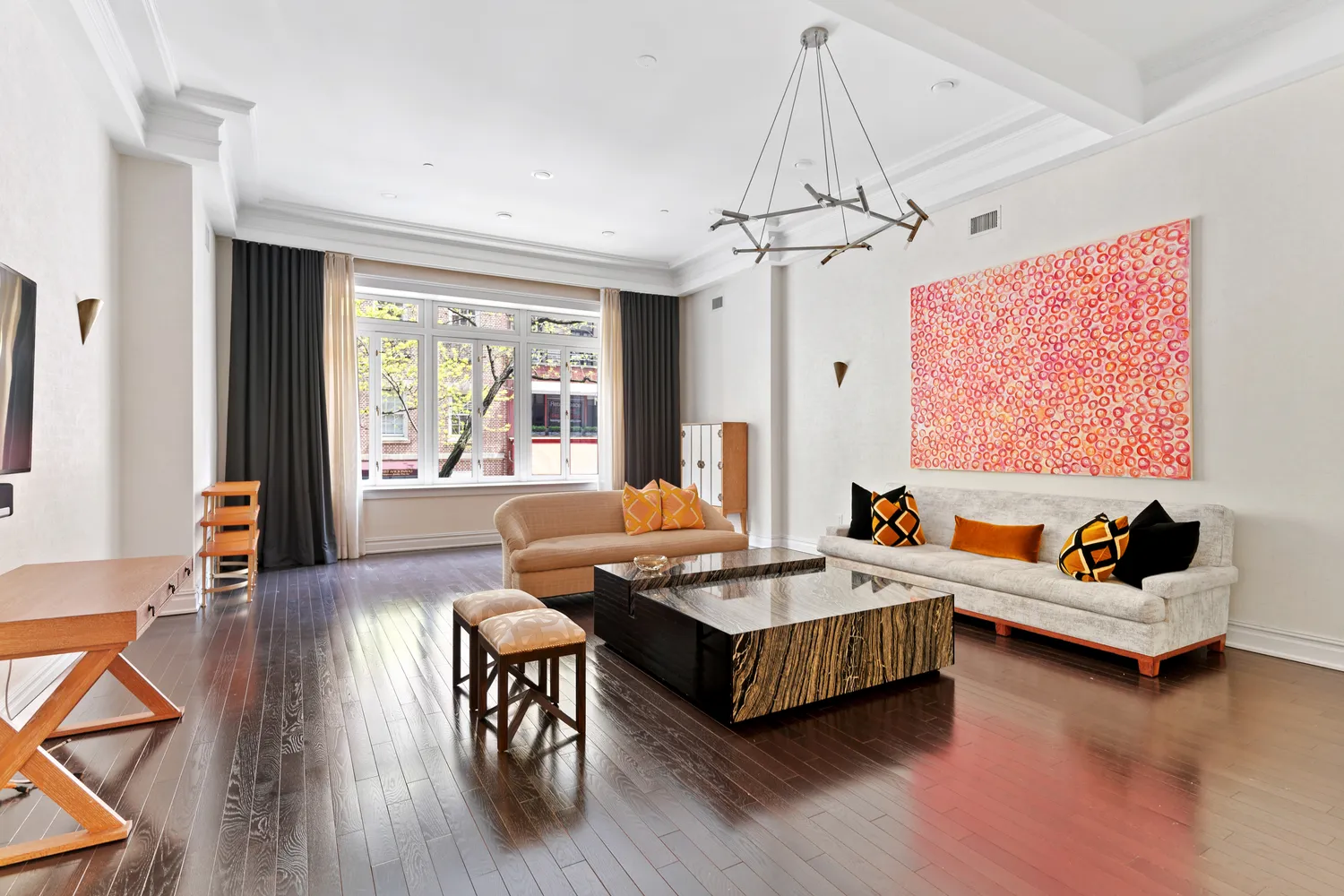 a living room with furniture and a chandelier
