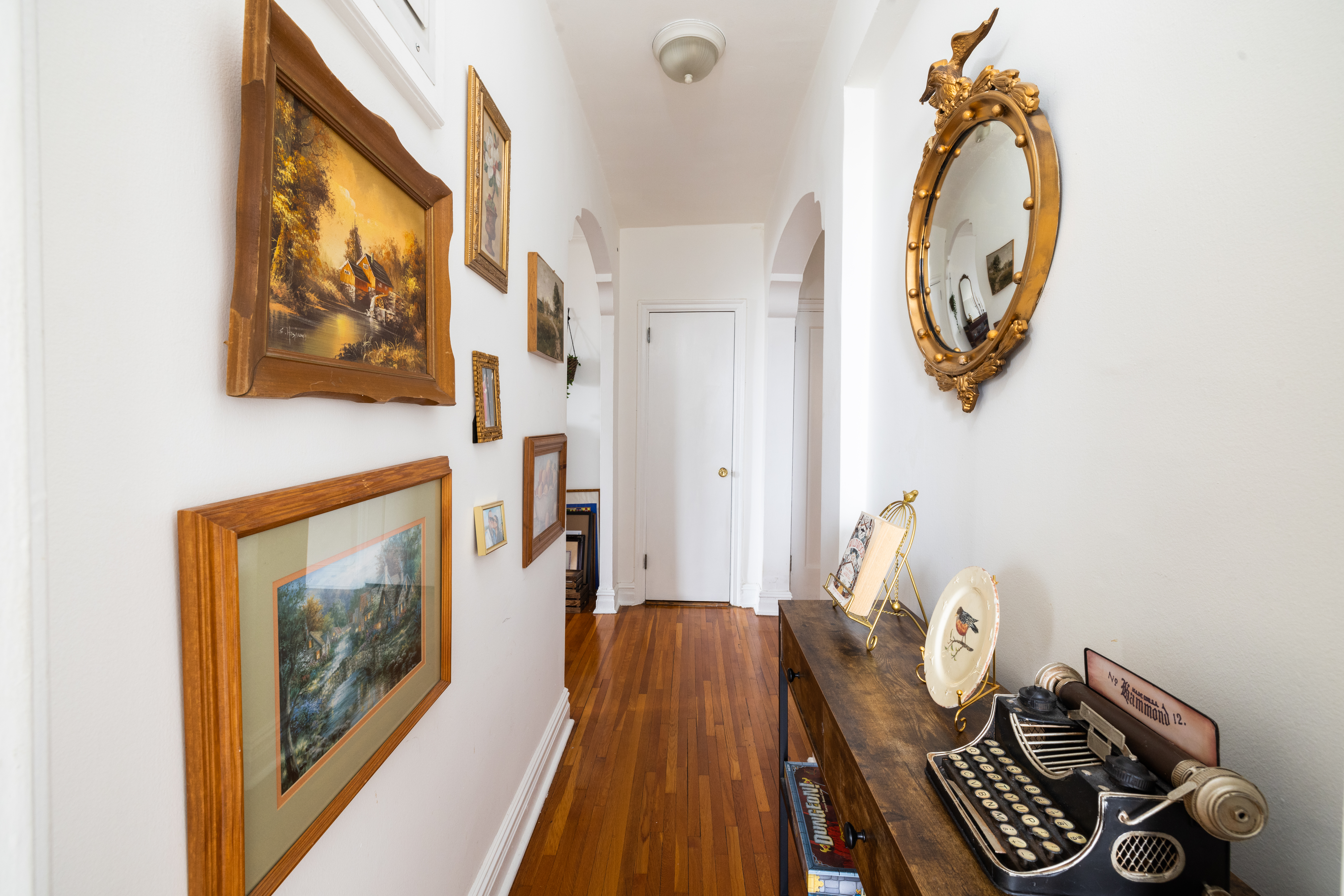 1680 Ocean Avenue, Unit 6D Brooklyn, NY 11230 - Photo 6 of 9 a view of a hallway with paintings on the wall