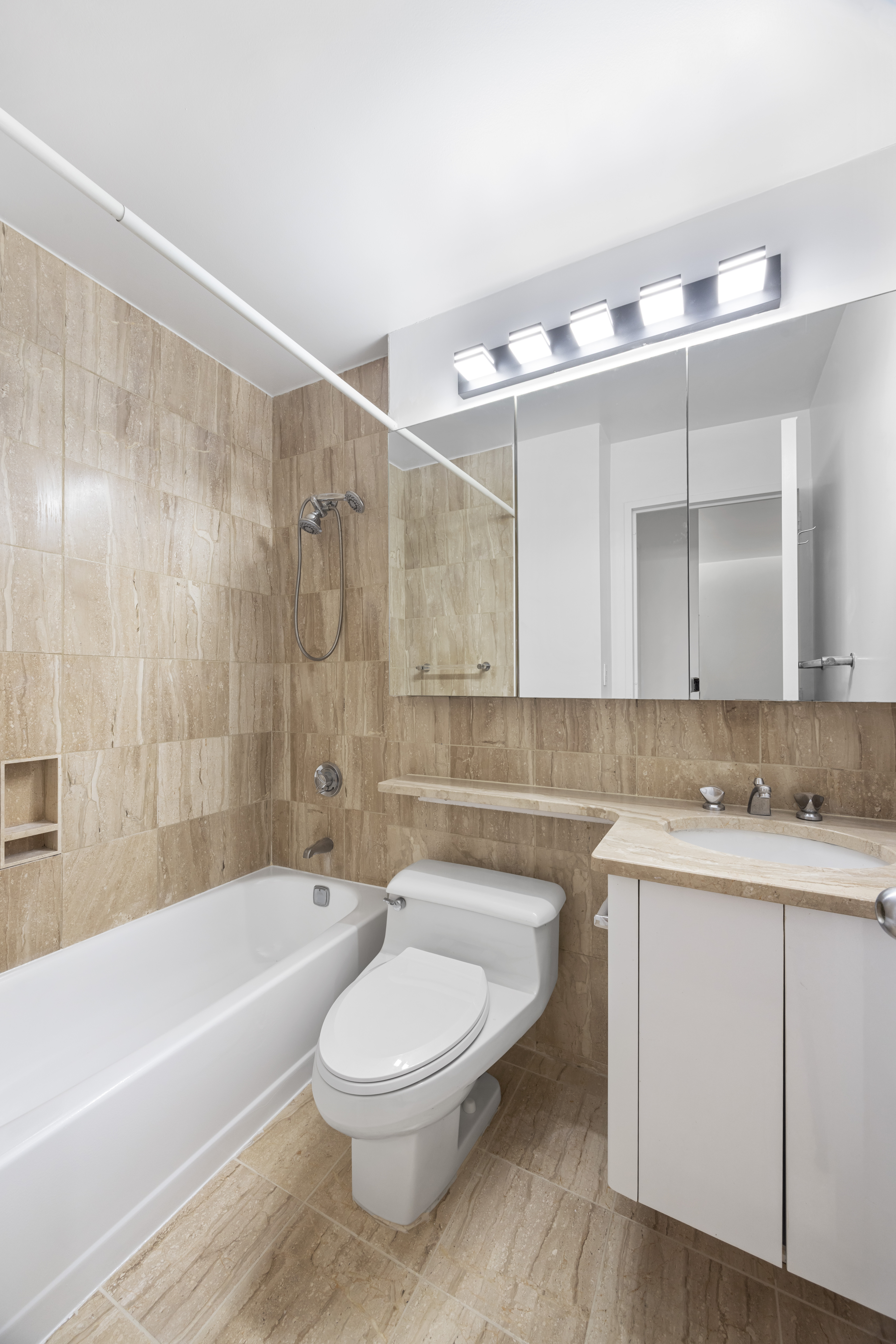 415 East 37th Street, Unit 16F Manhattan, NY 10016 - Photo 8 of 10 a bathroom with a sink a toilet and bathtub