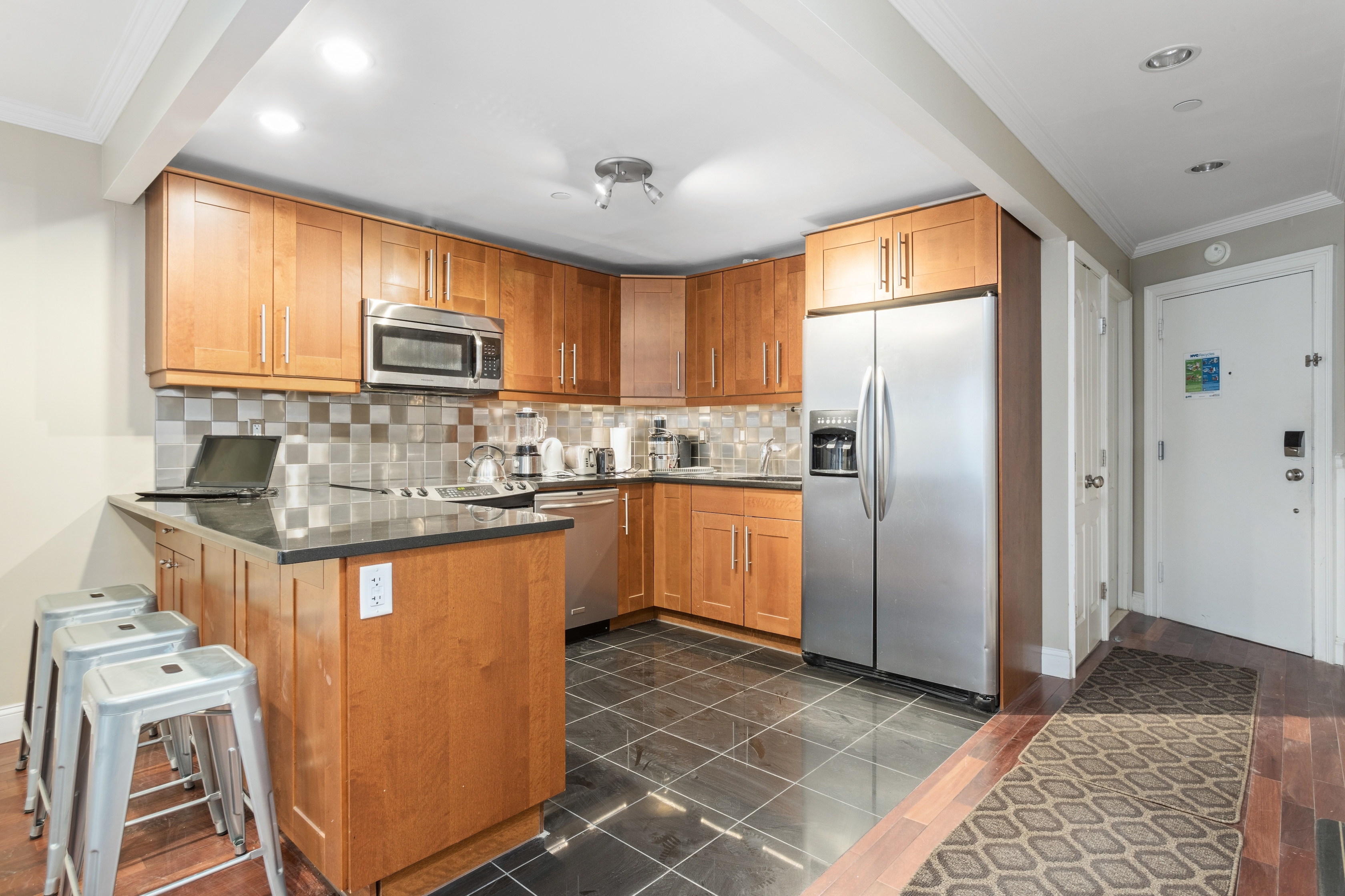 258 West 71st Street, Unit BR Manhattan, NY 10023 - Photo 7 of 13 a kitchen with stainless steel appliances granite countertop a refrigerator a stove a sink and a microwave