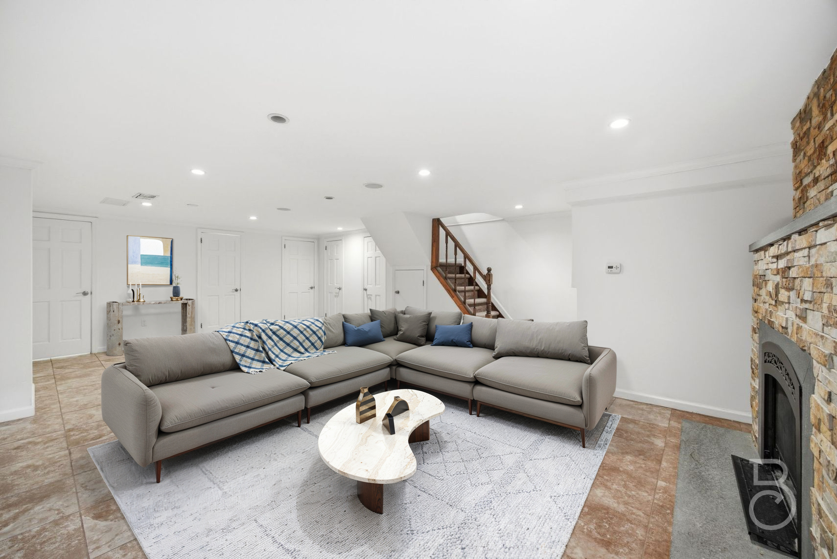 22-61 46th Street Queens, NY 11105 - Photo 10 of 24 a living room with furniture a fireplace and a flat screen tv
