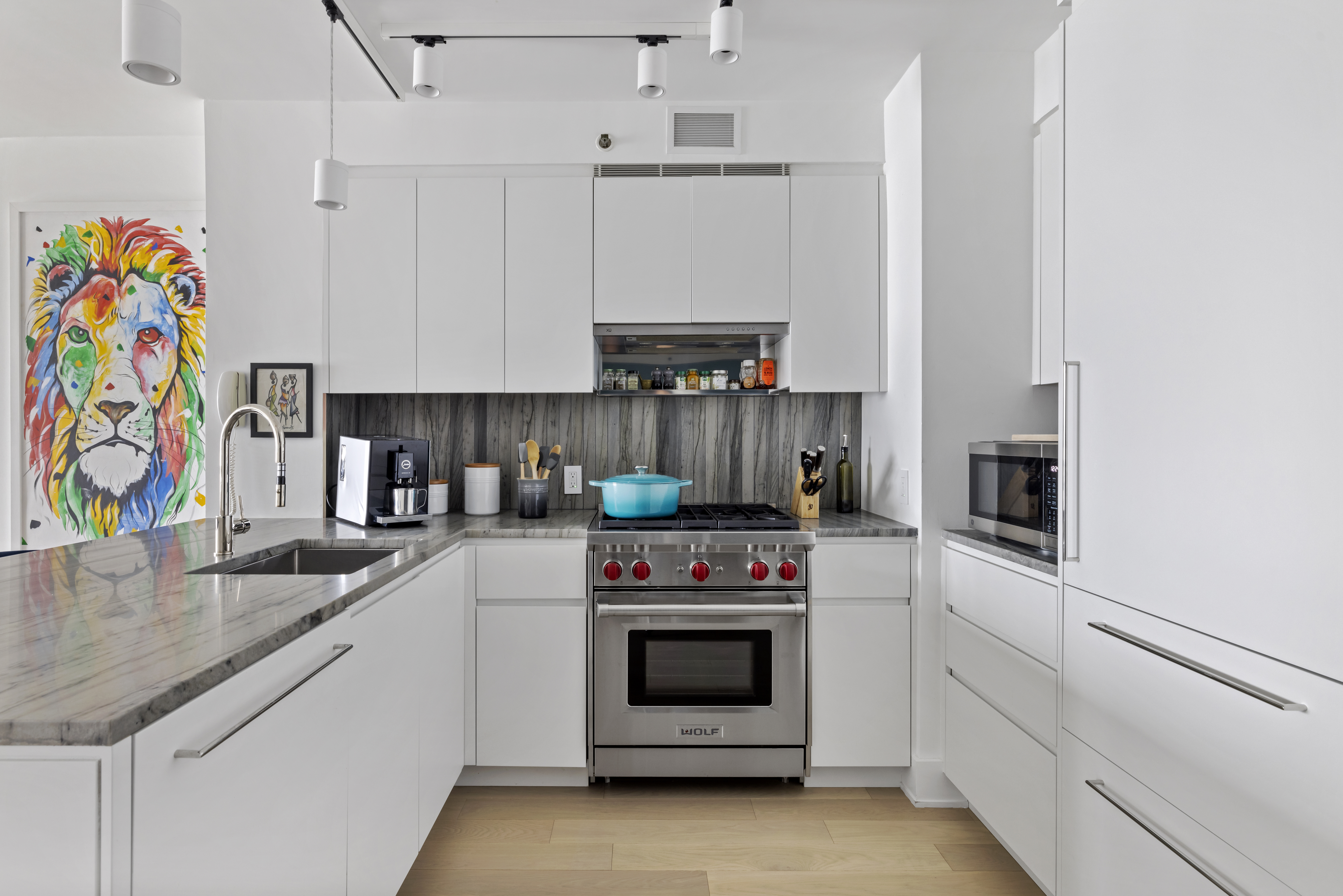 20 River Terrace, Unit 7K Manhattan, NY 10282 - Photo 5 of 9 a kitchen with stainless steel appliances granite countertop a stove and a sink