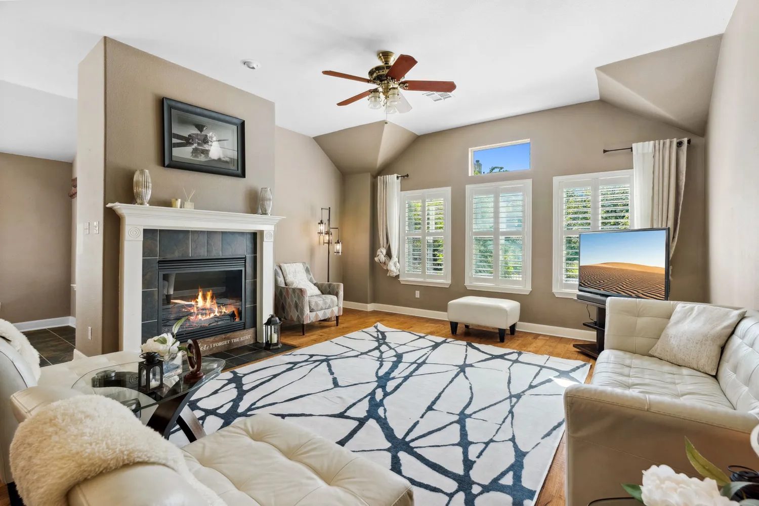 a living room with furniture and a fireplace
