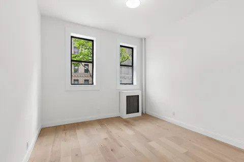 an empty room with windows and closet